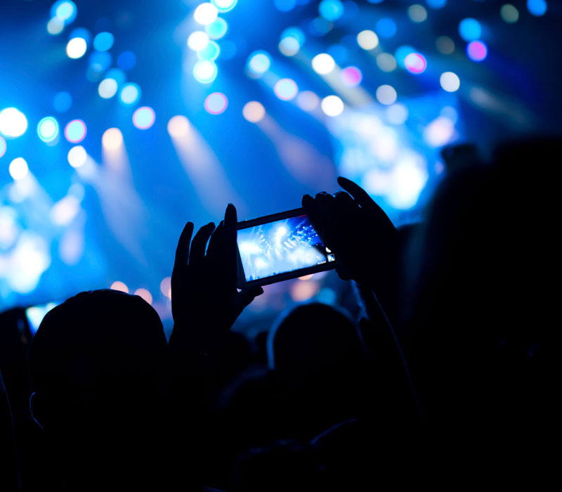 cell phone at darkened concert