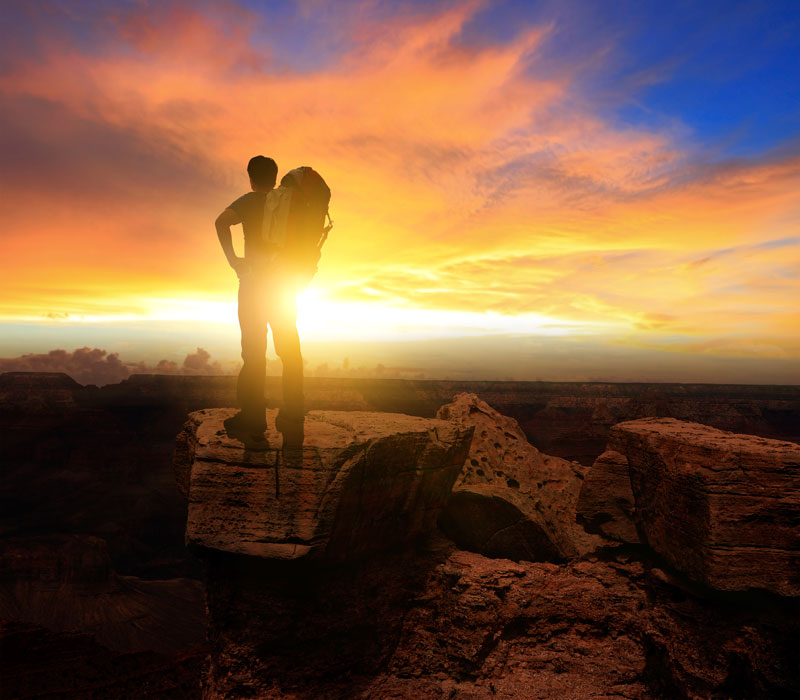 hiker looking into the sunset