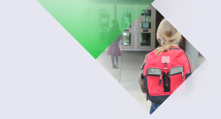 Young girl with backpack on walking towards school