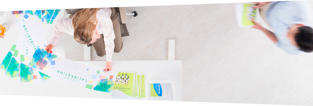Woman at desk looking at print outs 